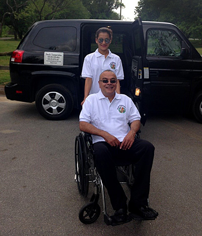 Cesar's family services drivers sitting in a wheelchair